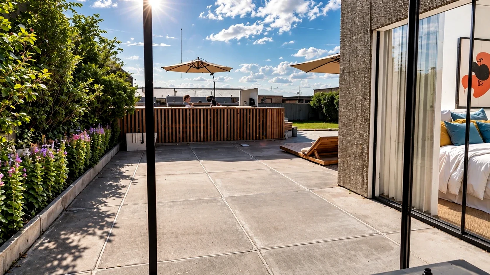 Open air terrace with custom lounge loungers, mature palms, and floor-to-ceiling glass sliding doors.